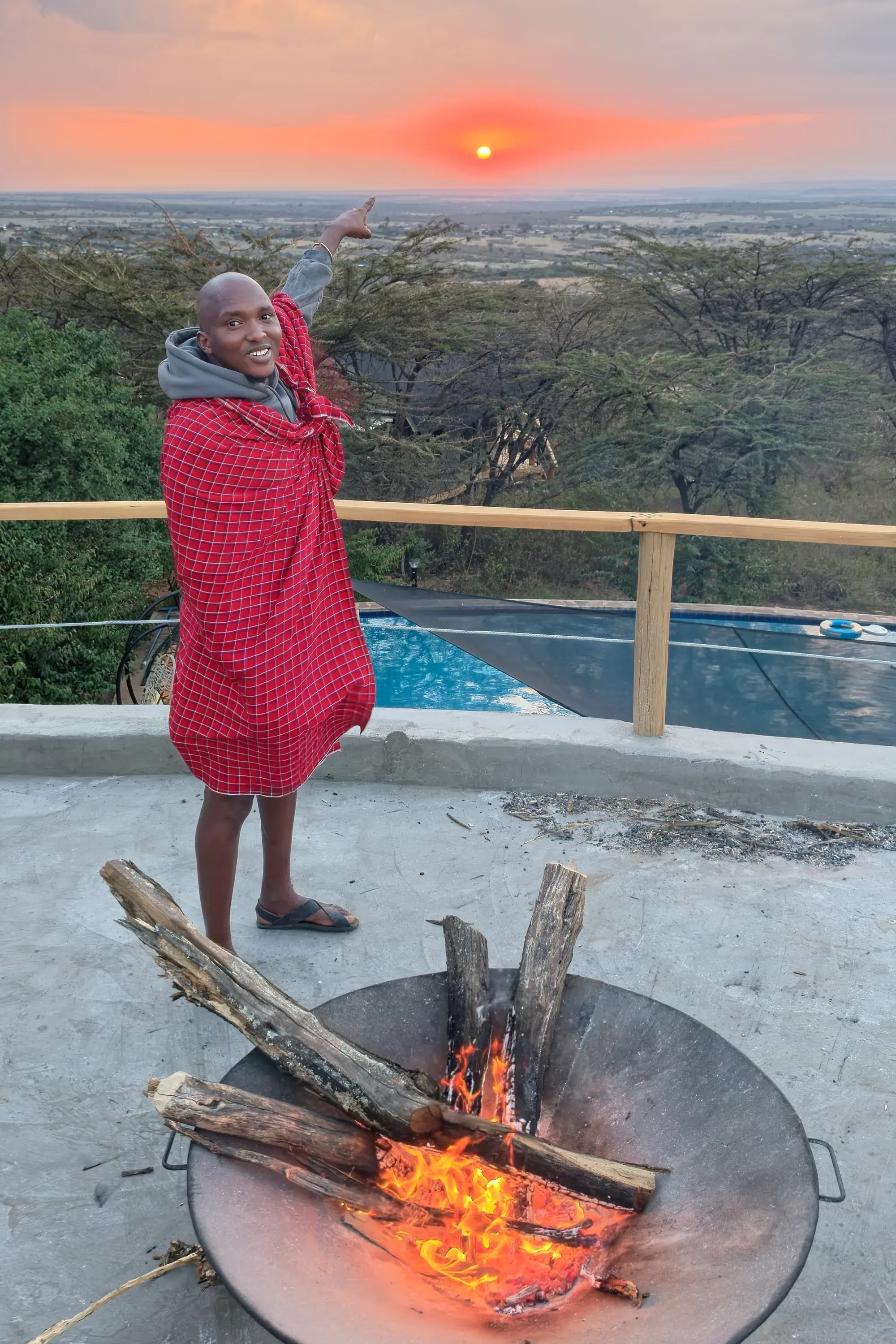 Sundowner fire on the rooftop deck, with the sun setting over the plains