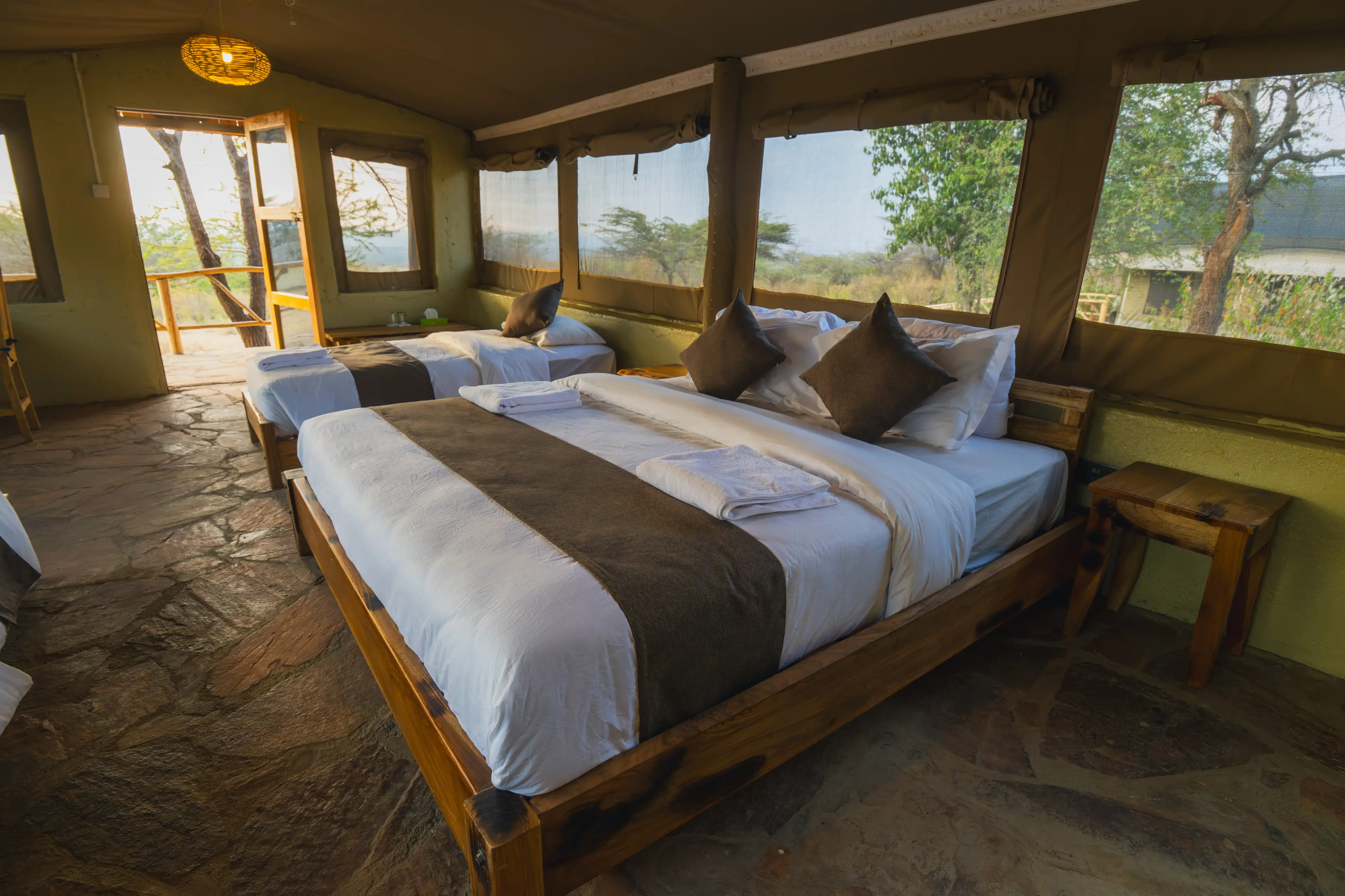 Standard room double bed on a stone floor