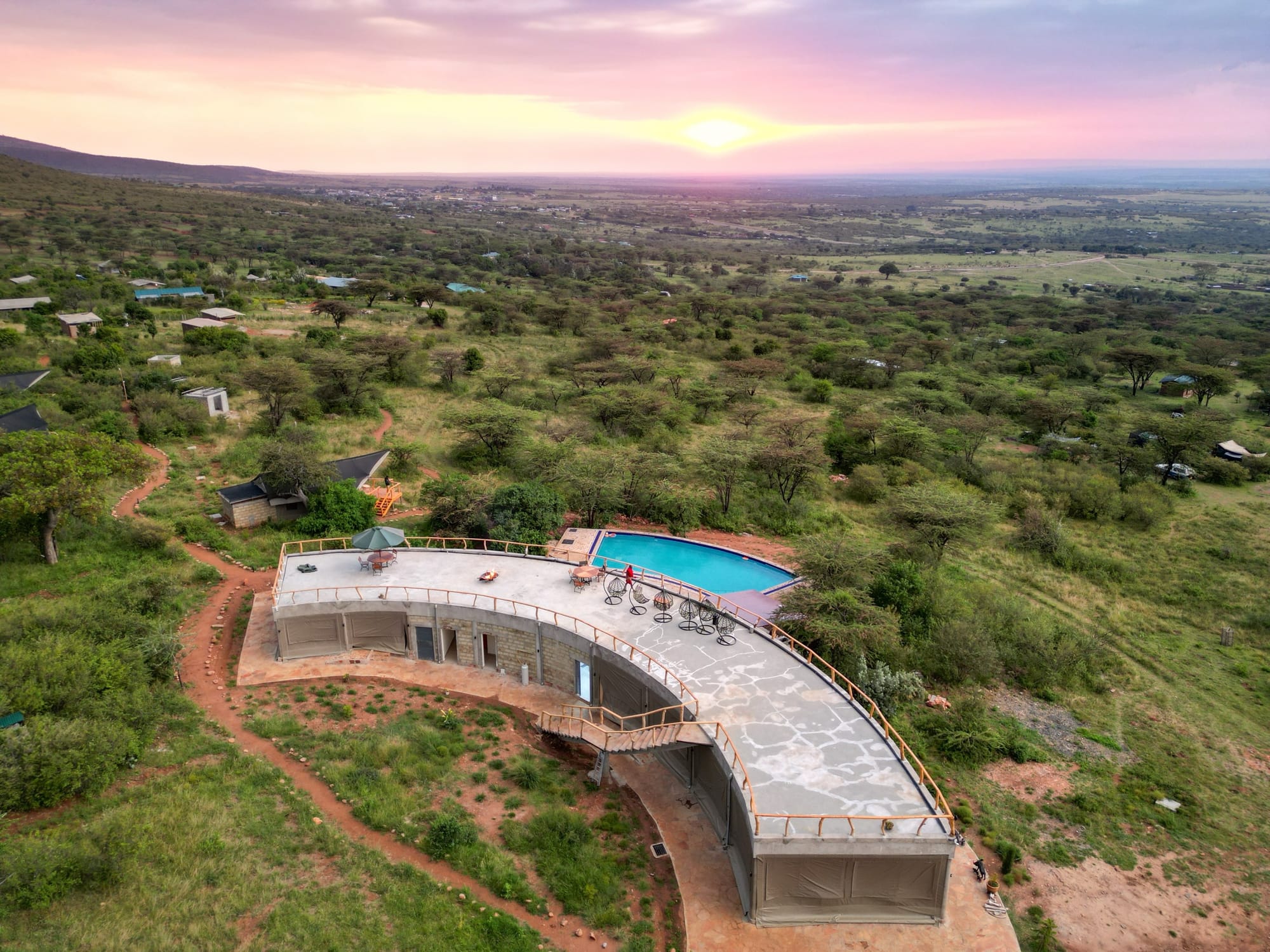 Aerial view of Mara Hilltop's hillside grounds near Sekenani Gate at sunset