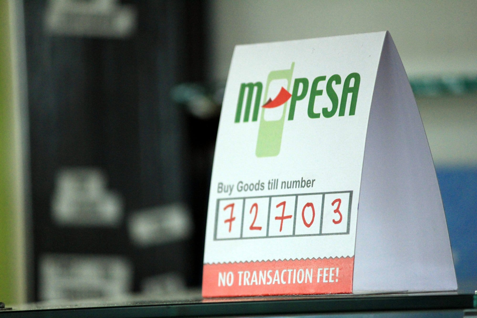 An M-Pesa Buy Goods till number sign standing on a shop counter in Kenya